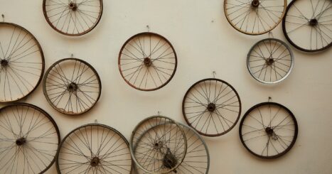 Various old wooden bicycle wheels mounted on a wall