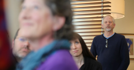 Henry Fersko-Weiss stands at back of a crowded class