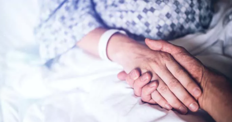 patient and visitor holding hands