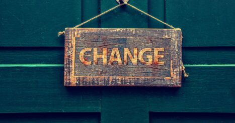 Wooden "Change" sign hangs on green door