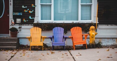 multicolored Adirondack chairs along sidewalk