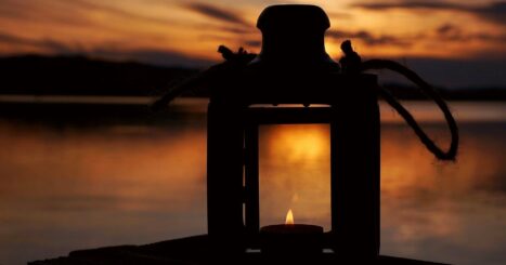 Lantern next to a lake at sundown